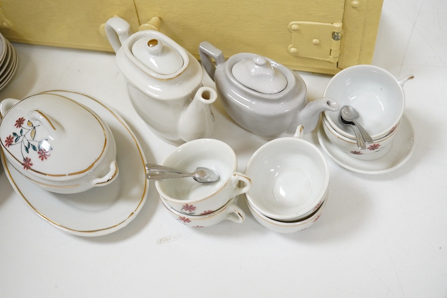 A 1930's handmade painted toy dresser with a miniature dinner service stamped ‘Foreign’ to the bases, comprising teapot, tureen, serving dish, plates, cups, etc. Condition - fair.